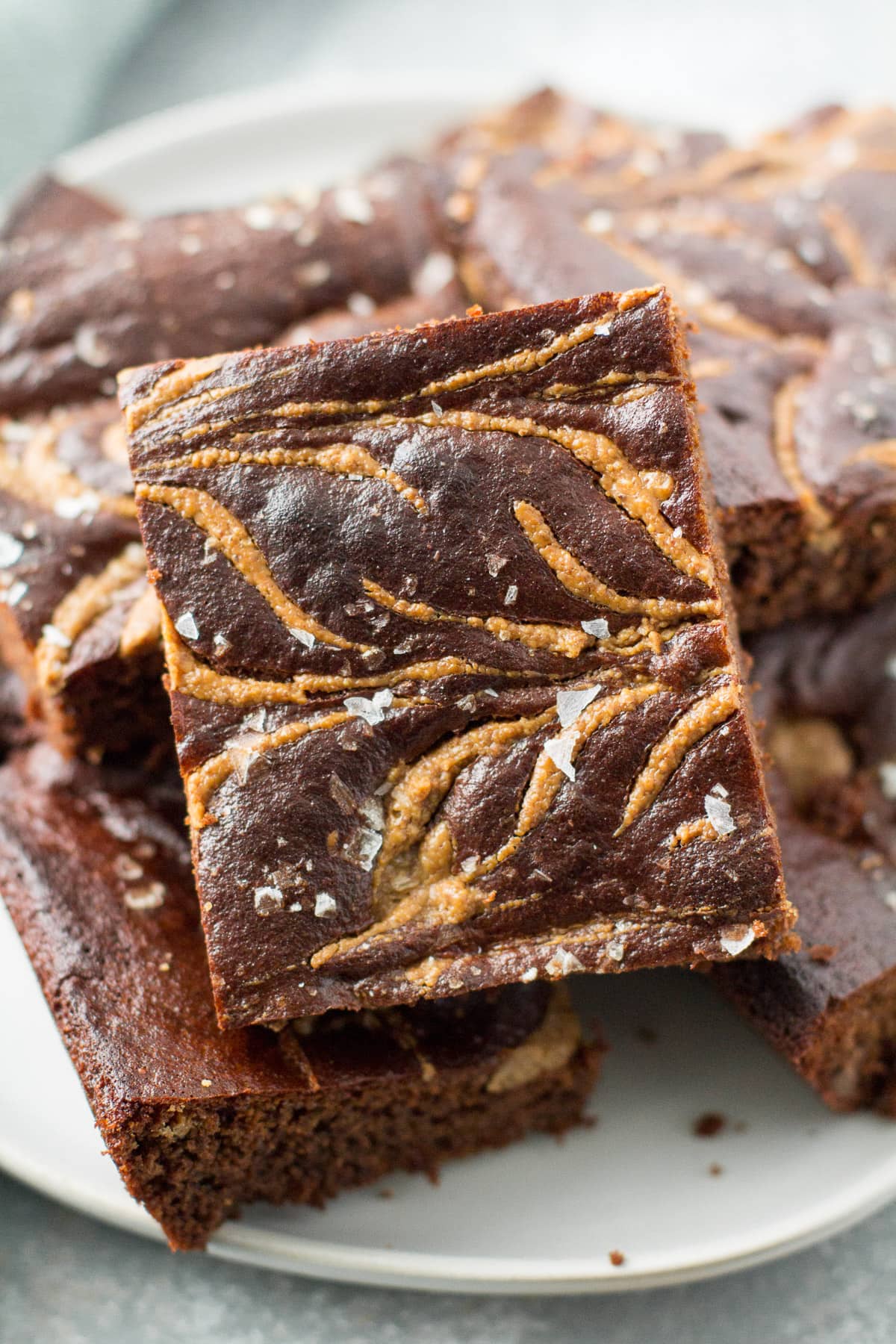 A close up of Almond Butter Brownies on a white plate