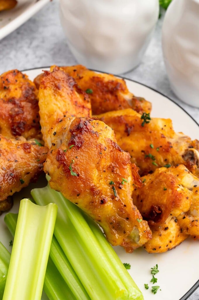 Baked Chicken Wings on a plate with celery on the side.