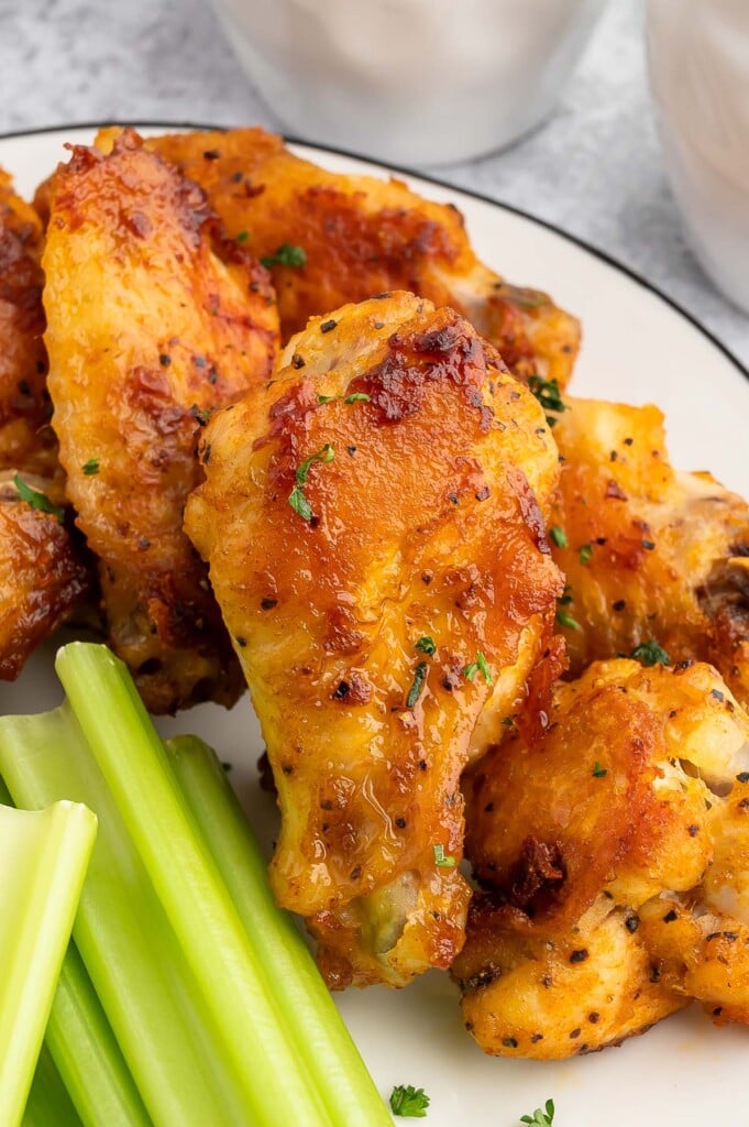 Baked Chicken Wings on a plate with celery on the side.