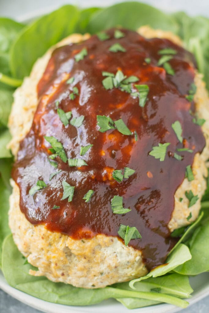 Instant Pot meatloaf on a spinach lined plate