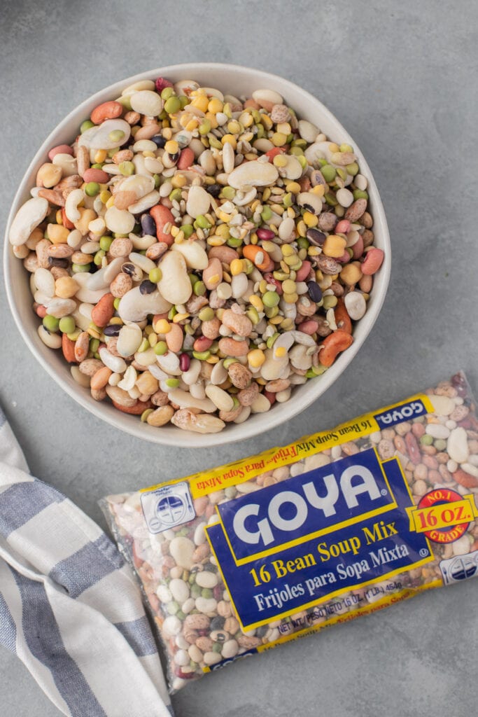 A bowl of mixed beans with 15 bean soup mix on the side a dry bean mix