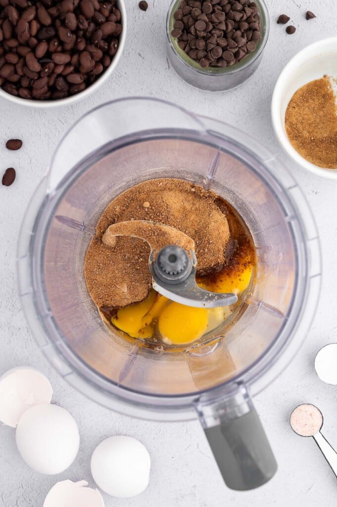 Eggs and coconut sugar in a food processor before blending together with other ingredients on the side