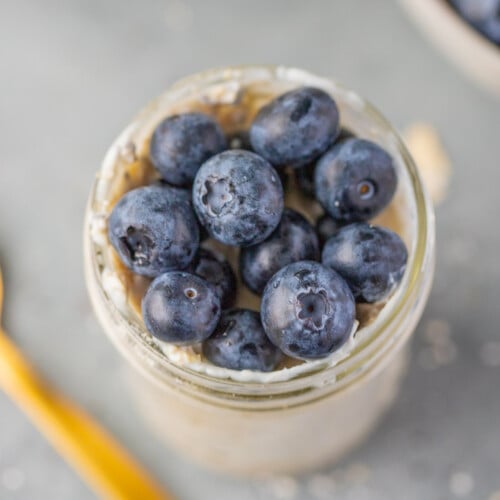 Blueberry Overnight Oats in a mason jar on a grey background