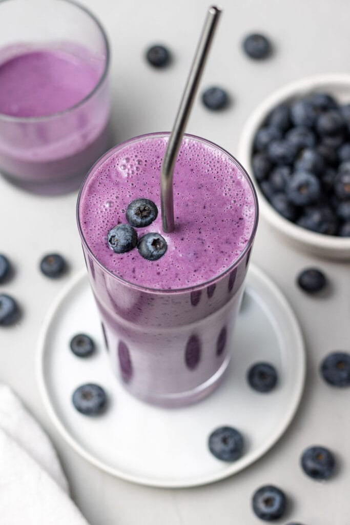 Blueberry Smoothie on a white dish on a grey background