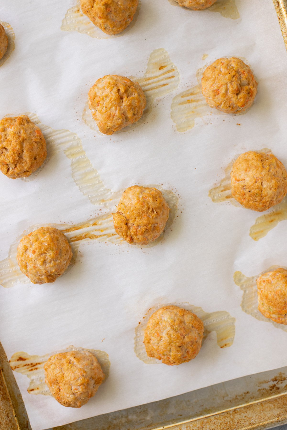 A baking sheet of cooked buffalo chicken meatballs
