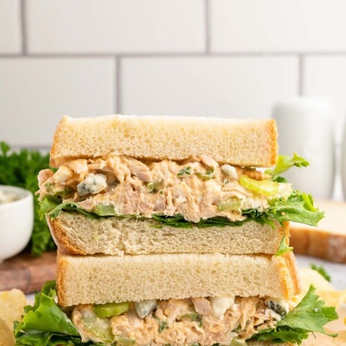 Buffalo Chicken Salad Sandwich cut in half and stacked on top of each other with a white background.