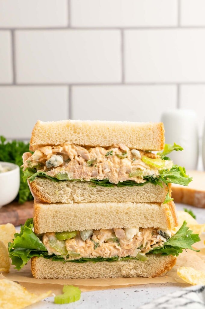 Buffalo Chicken Salad Sandwich cut in half and stacked on top of each other with a white background.