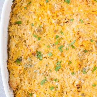 Buffalo Chicken Spaghetti Squash Casserole in a white dish on a grey background.