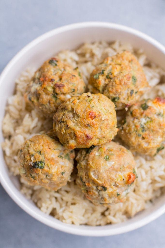 Buffalo turkey meatballs over a bowl of rice