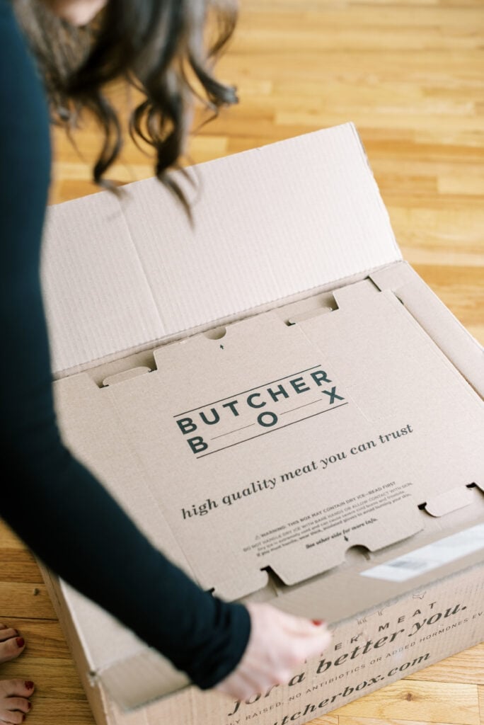 Butcherbox packaging - a girl opening a butcherbox 