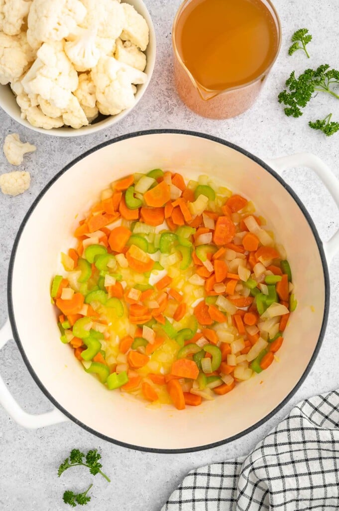 Onions, carrots, and celery after sauteing in a stock pot for cauliflower soup