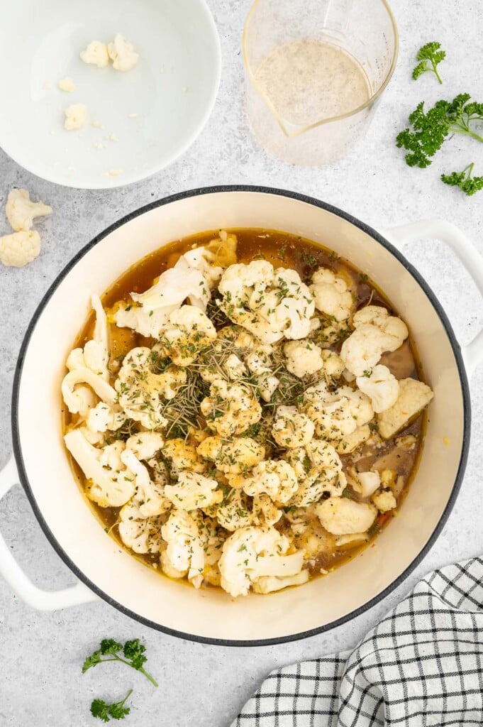 All ingredients for cauliflower soup (except milk and cheese) in a stock pot before cooking