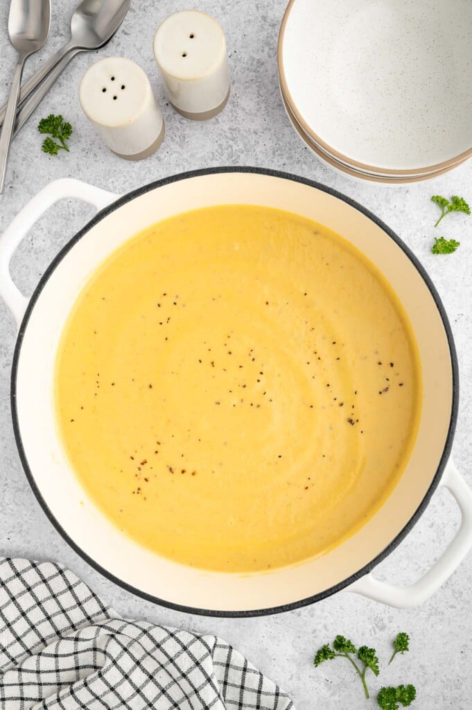 An overhead shot of a stock pot of creamy cauliflower soup after cooking and blending