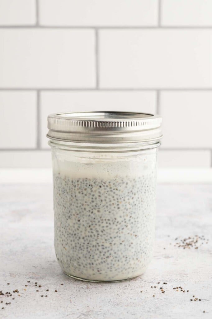 Fully set chia seed pudding in a mason jar with a lid on it.
