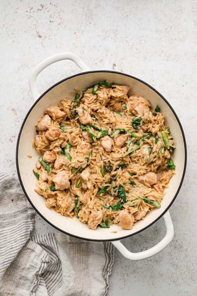 An overhead shot of chicken orzo in a dutch oven