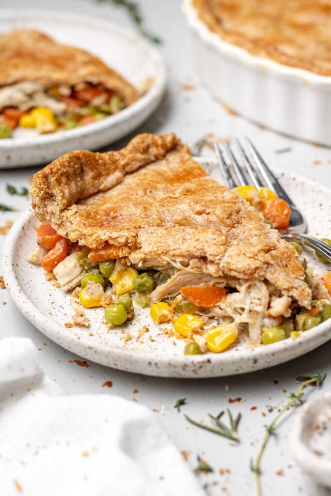 A piece of Healthy Chicken Pot Pie on a white plate with a fork