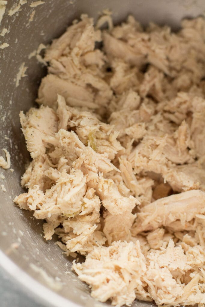 shredded chicken for chicken pot pie soup in a metal bowl