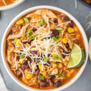 An overhead shot of chicken taco soup in a white bowl with another bowl to the side