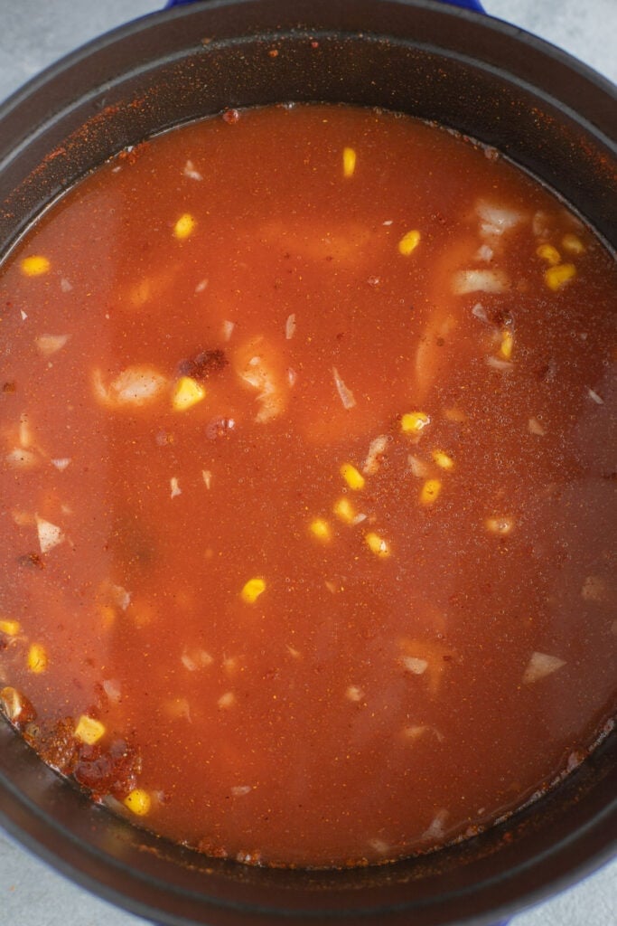 chicken taco soup in a pot fully cooked with chicken unshredded