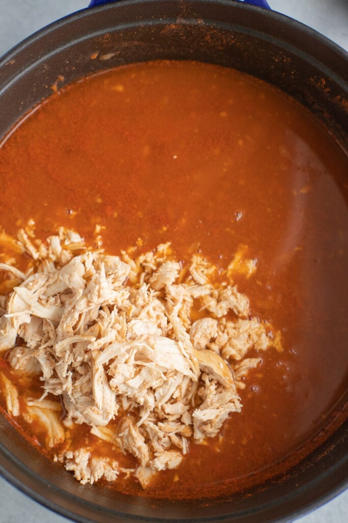 chicken taco soup in a pot fully cooked with chicken being added back in after shredding
