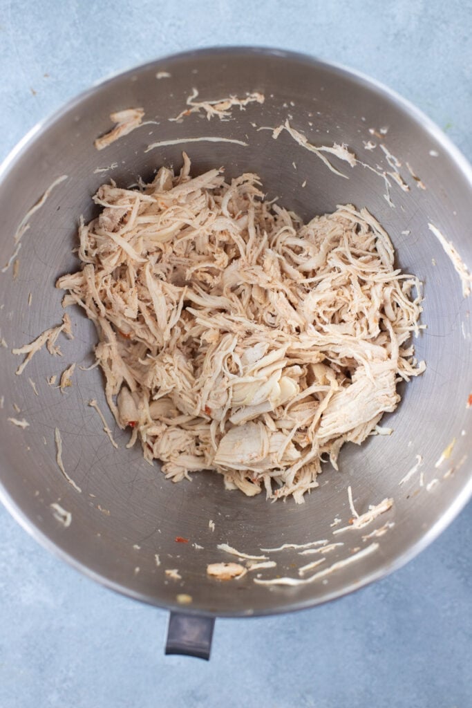 shredded chicken in a kitchen aid bowl