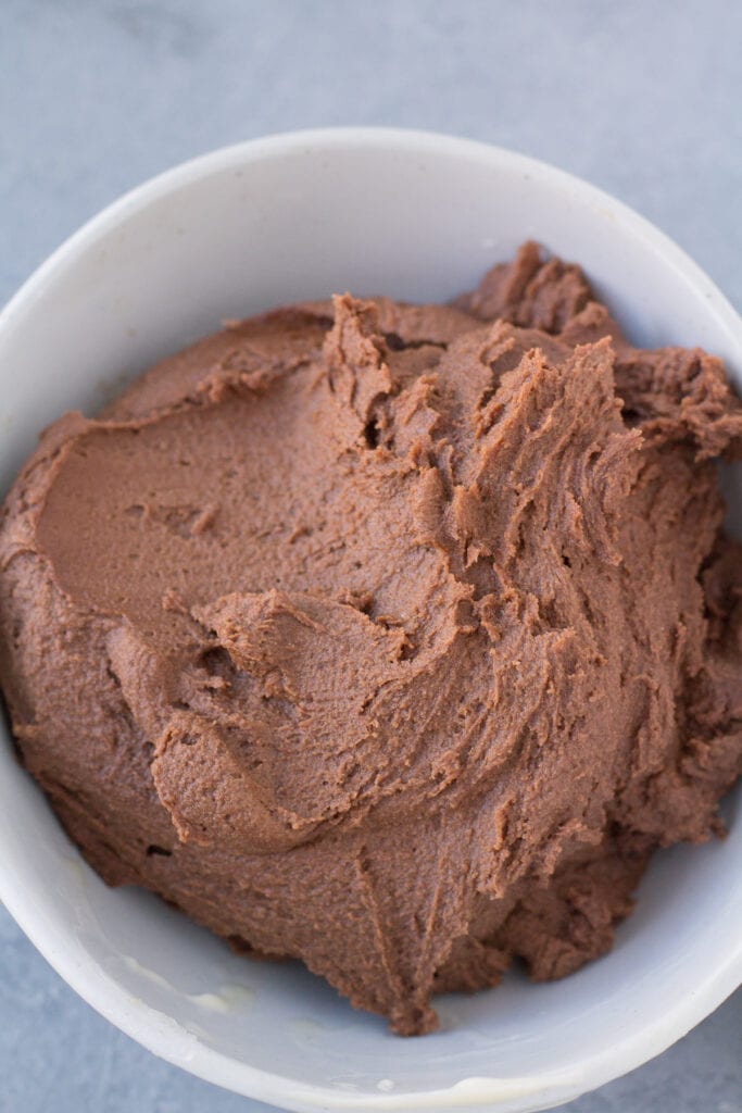 dough for chocolate caramel thumbprints in a white bowl