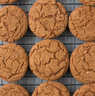 A close up of The BEST Crispy Gingersnap Cookies on a cooling rack