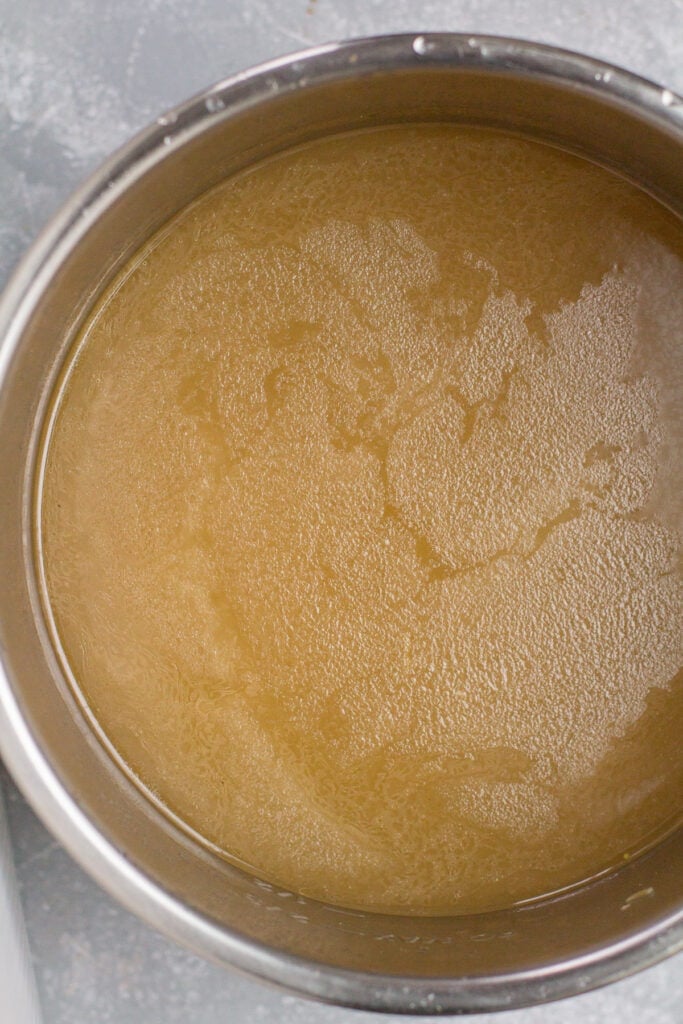 an overhead shot of a big pot of slow cooker bone broth