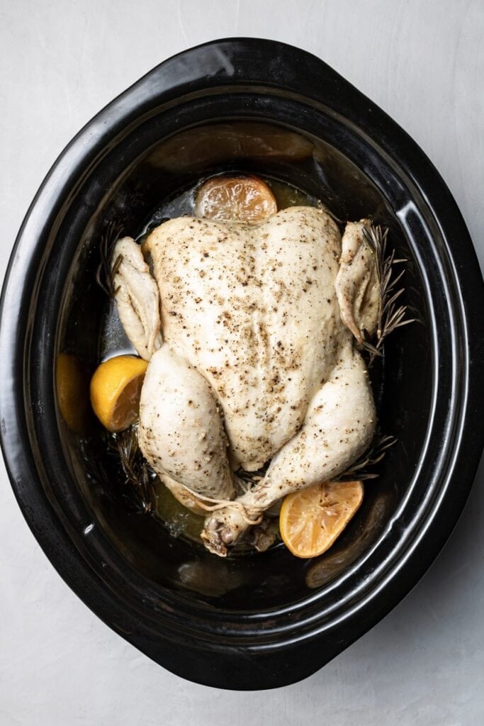 a whole chicken in a crockpot after being cooked