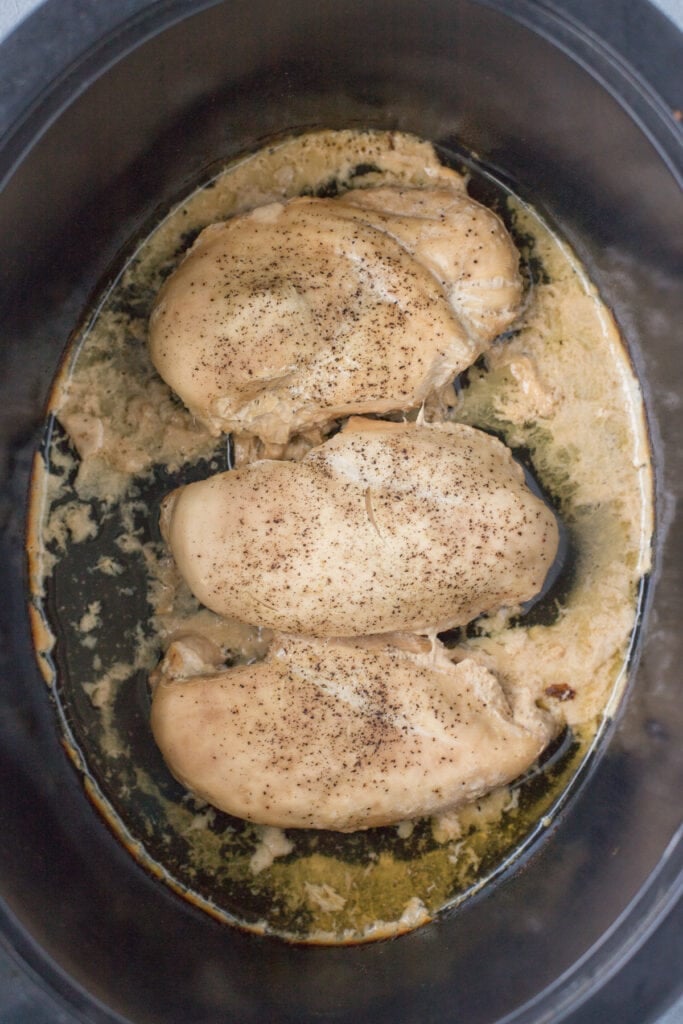 chicken breasts cooked in a slow cooker with juices