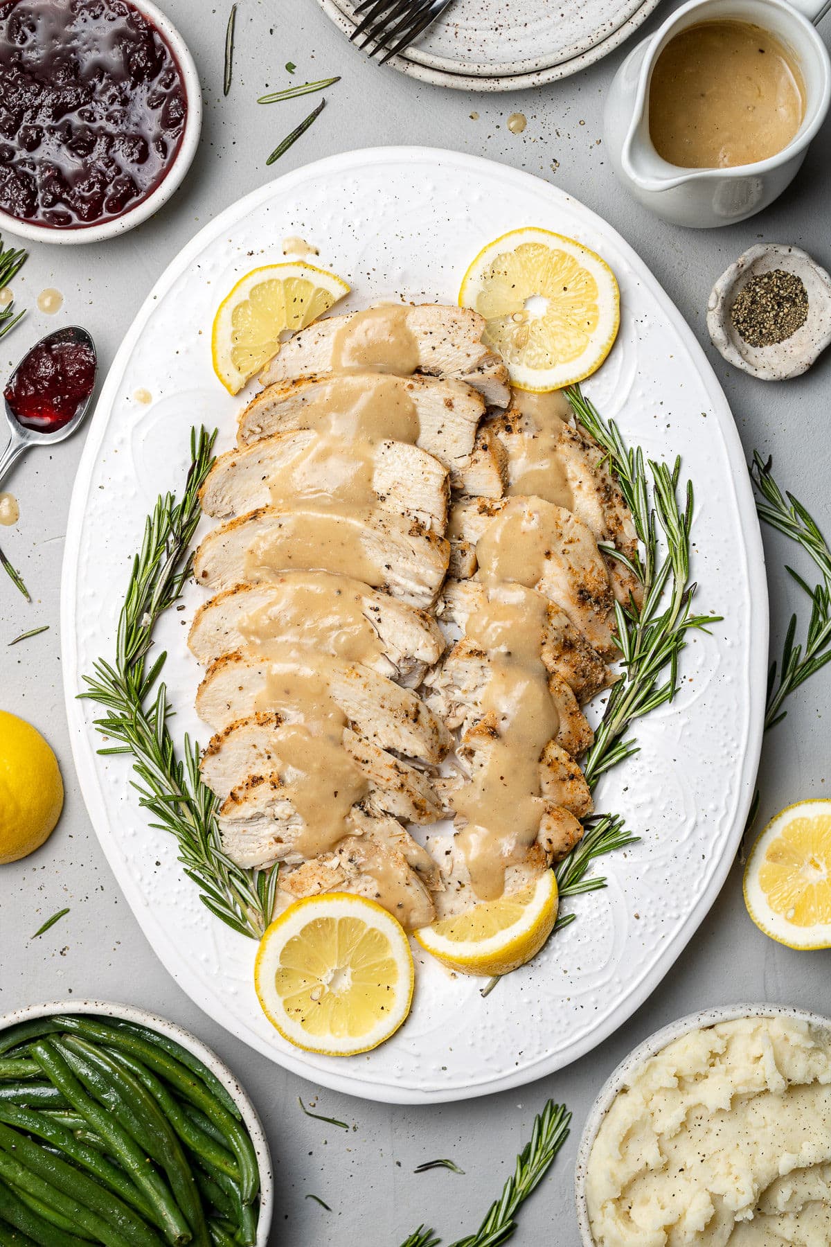 Crockpot turkey breast, sliced on a white platter