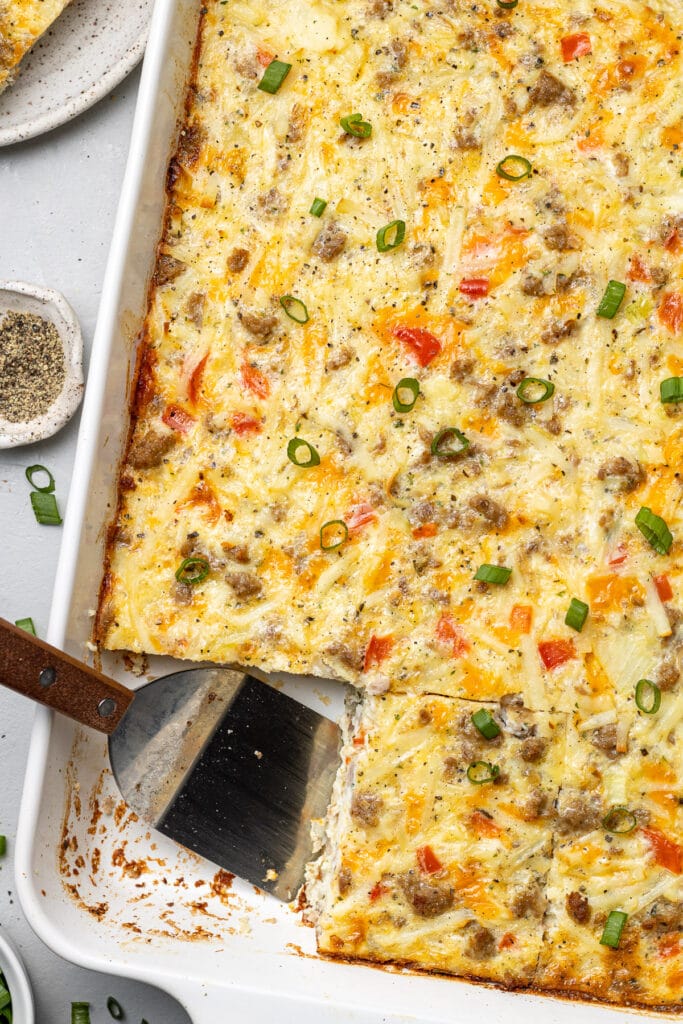 An egg and hash brown casserole with a piece taken out of it