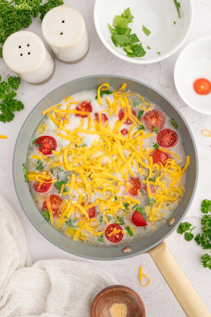 An unbaked egg white frittata topped with cheese. 