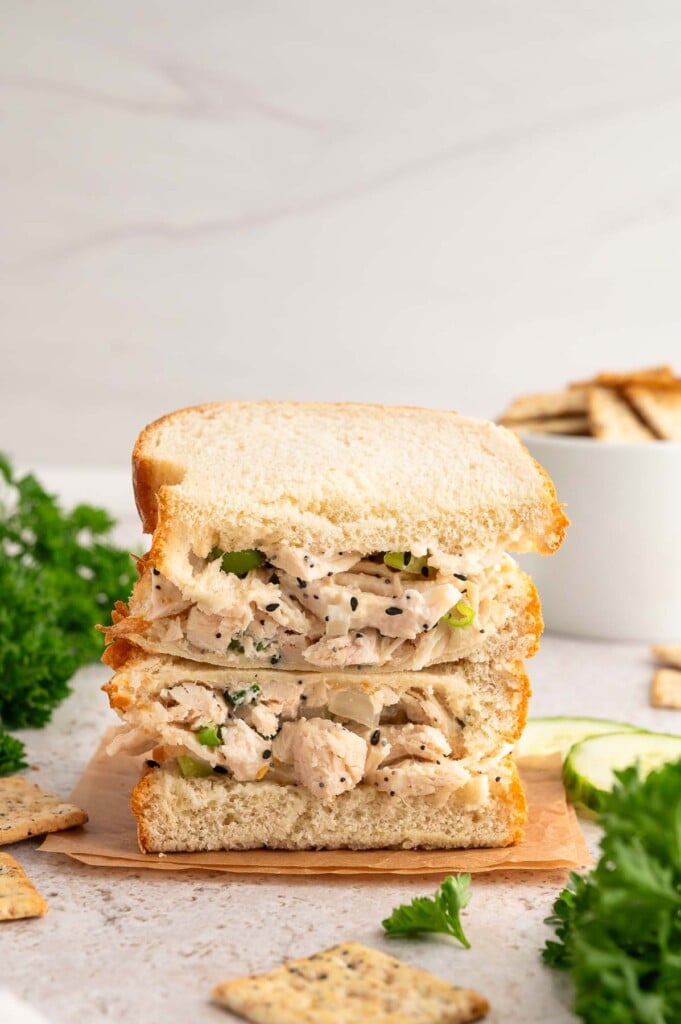 Everything Bagel Chicken Salad sandwich sliced in half and stacked on top of each other.