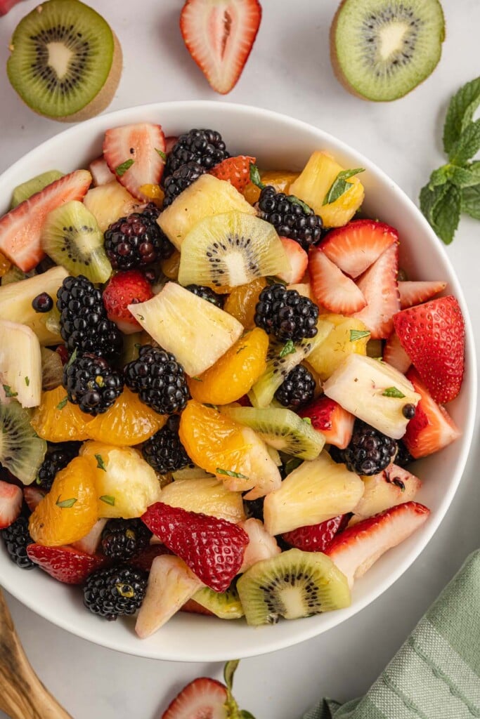 Fruit Salad with Mint in a white bowl.