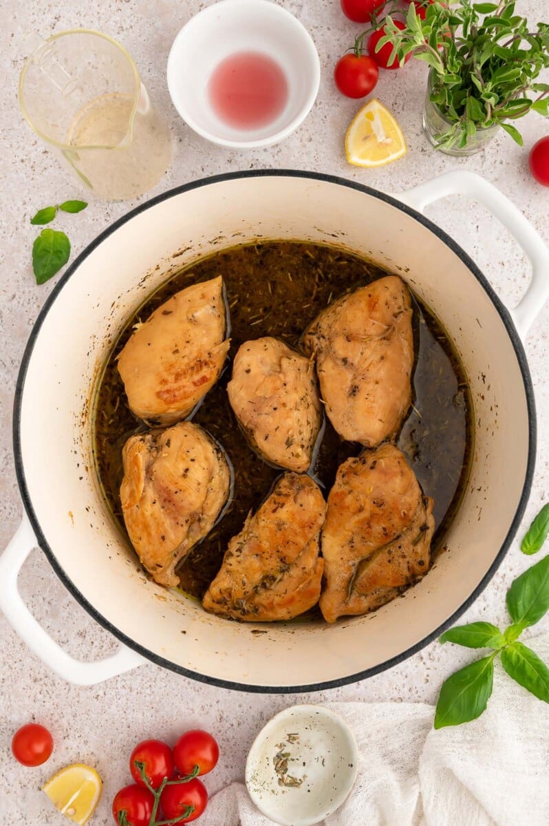 Greek chicken in a dutch oven after cooking before being shredded.