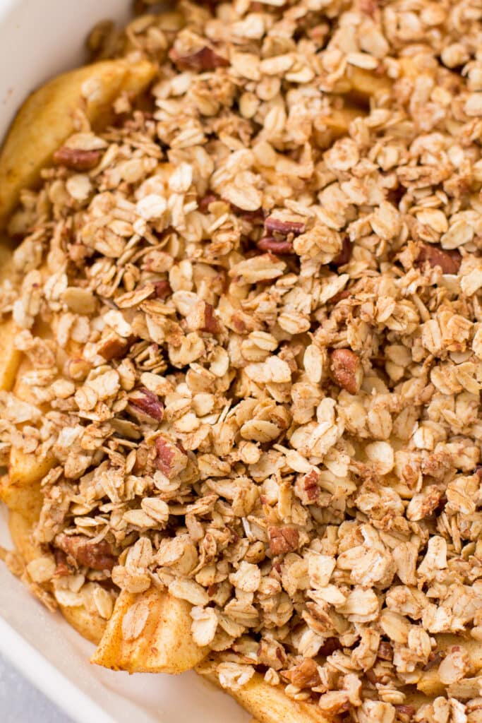 Healthy Apple Crisp in a white baking dish on a grey background
