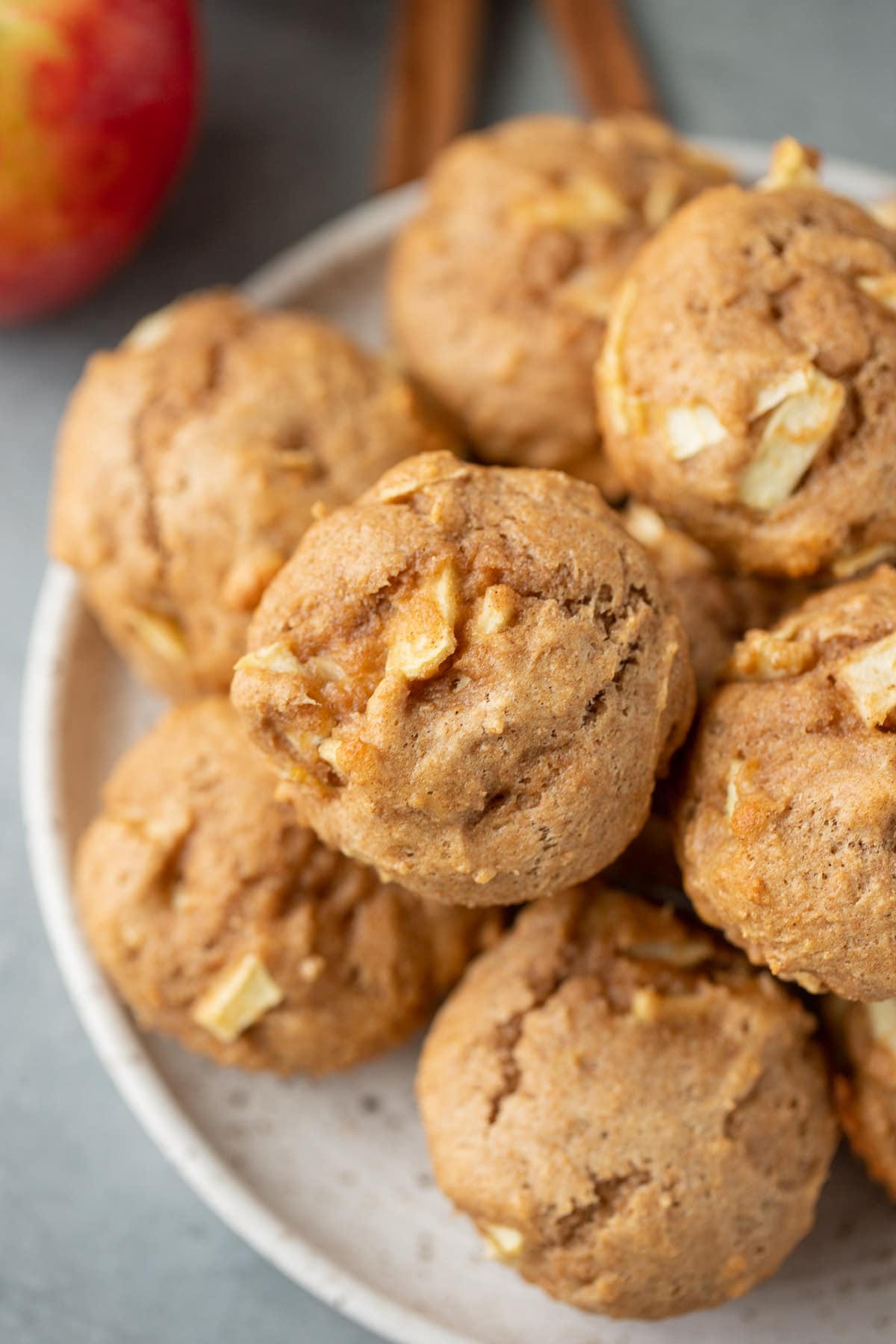 Healthy Apple Muffins on a white plate with a red and white linen in the back