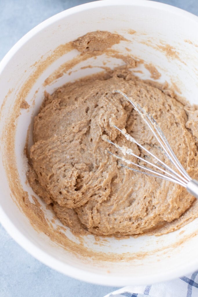 An overhead photo of healthy apple muffin batter being mixed together