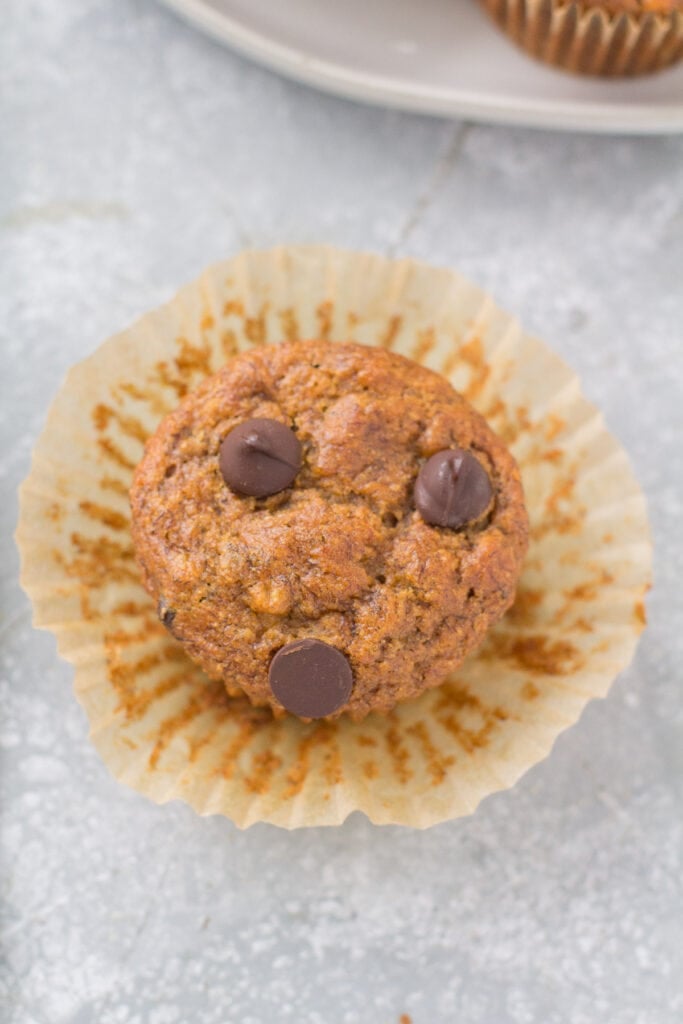 A Healthy Banana Muffin with the muffin liner unwrapped around it.