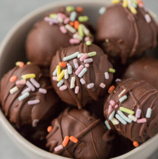 Healthy Brownie Truffles in a small white bowl on a grey background