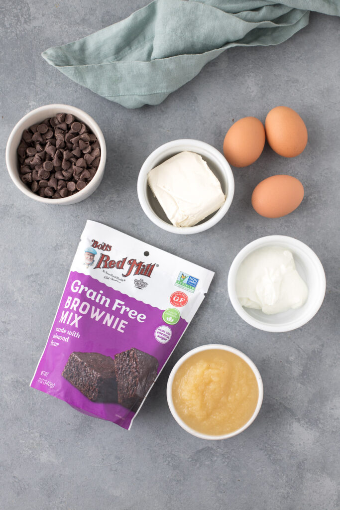 Ingredients for Healthy Brownie Truffles in small white bowls on a grey background