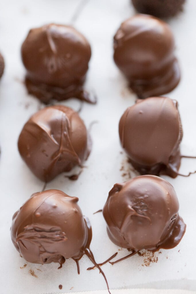 Gluten Free Brownie Truffles on a parchment lined baking sheet