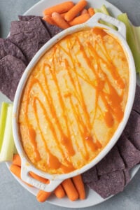 healthy buffalo chicken dip in a white dish fresh out of the oven.