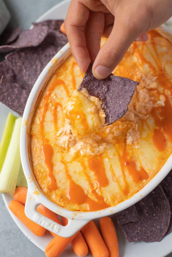 a chip dipping out some healthy buffalo chicken dip.