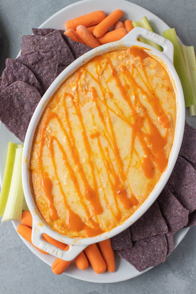 A white dish filled with warm skinny buffalo chicken dip