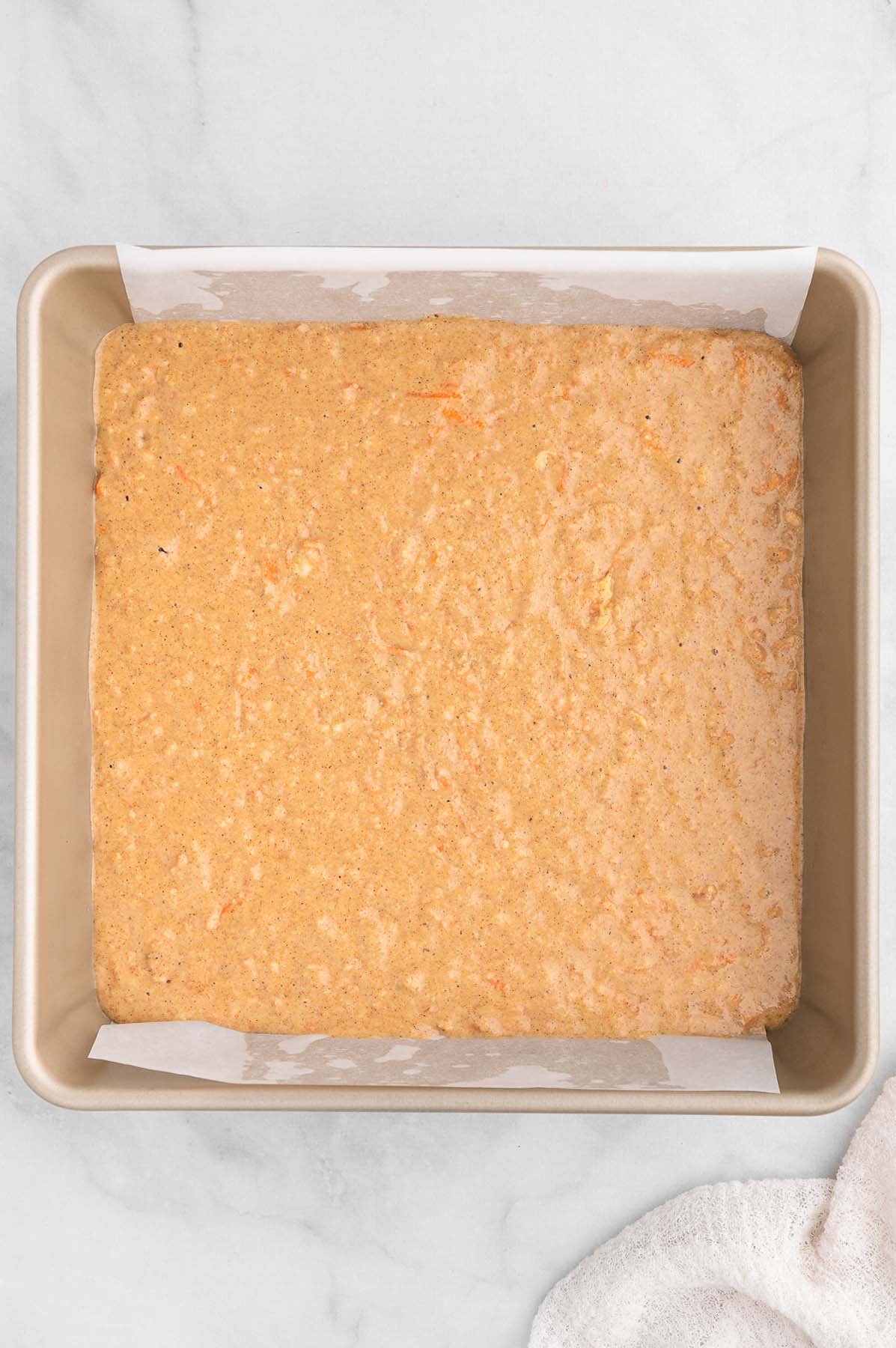 Batter for healthy carrot cake in a prepared baking pan before baking