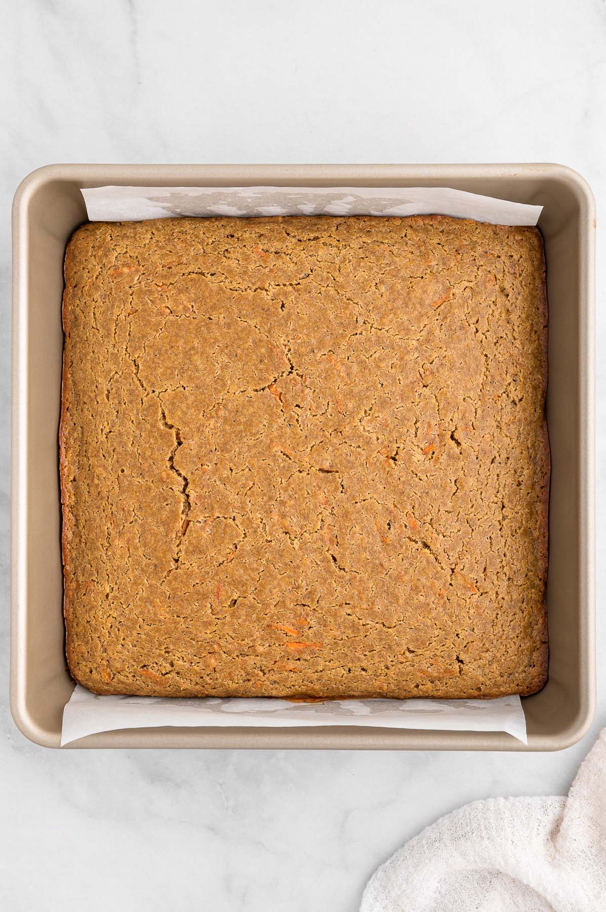 Healthy carrot cake in a prepared baking pan right after baking