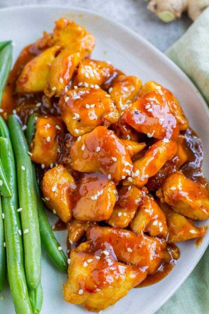 Healthy Orange Chicken on a white bowl.