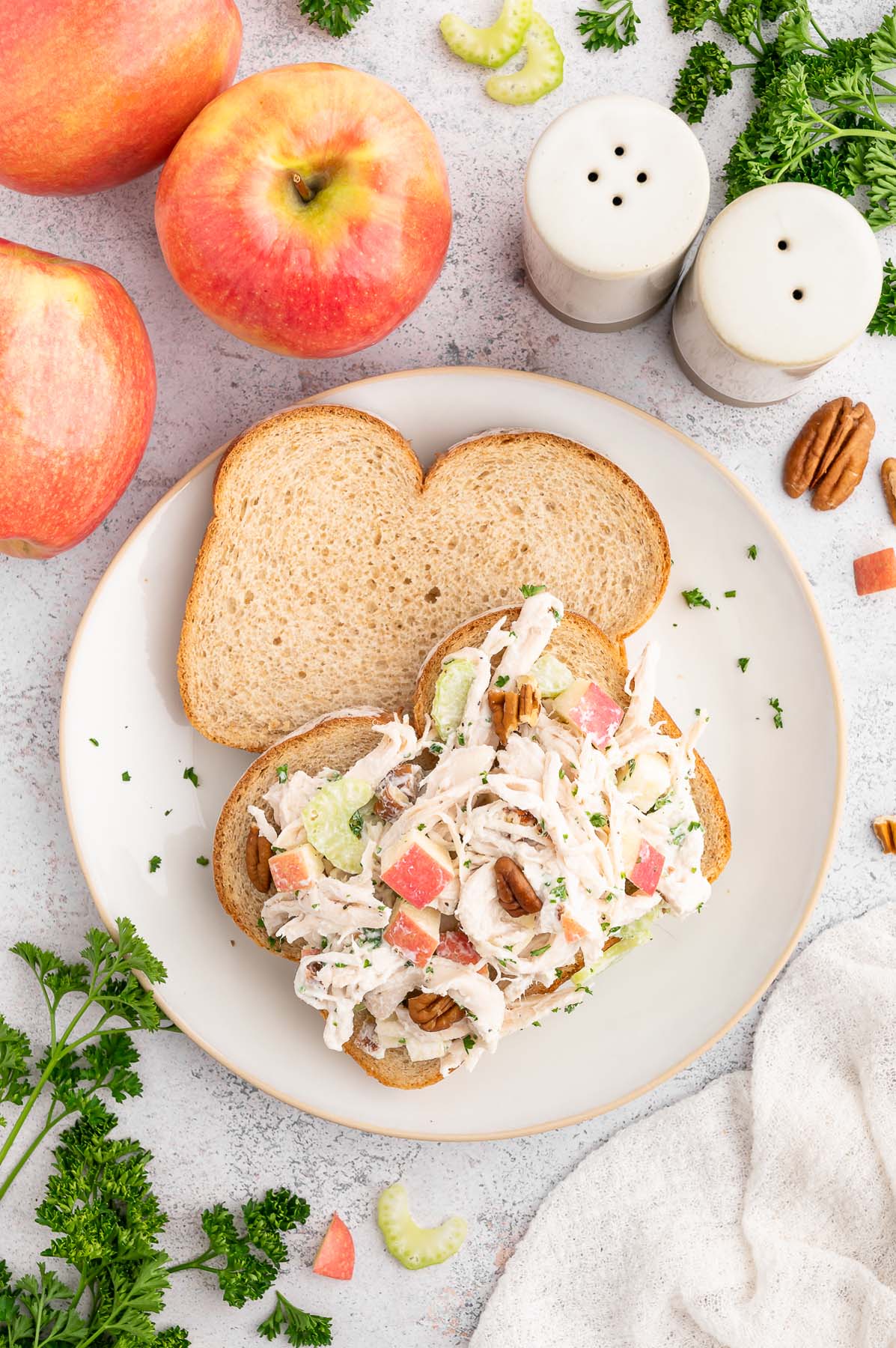 Greek Yogurt Chicken Salad on an open faced sandwich on a grey background